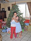 Johnny and Miranda in front of Christmas tree