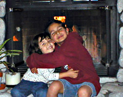 Johnny and Mirnada hugging each other in fromt of a fireplace