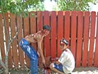 Christian and Johnny painting the fence?