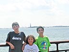 Kids with the Statue of Liberty behind them