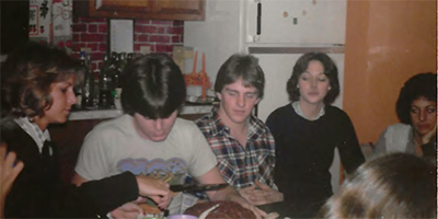 Friends cutting bitrthday cake