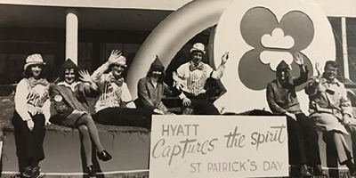 Hyatt employees on a float in a parade.